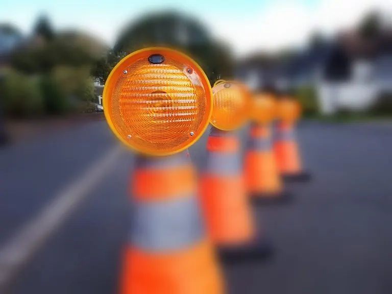 Illuminated traffic cone taper lamps on a road